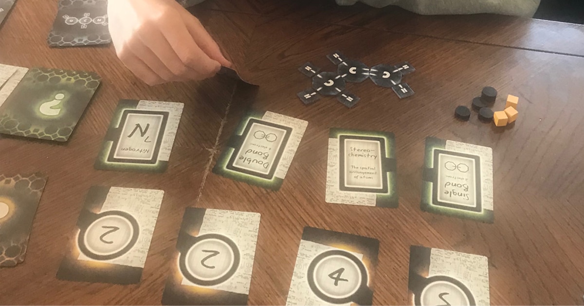 teens playing "Covalence" board game